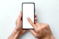 Person holding modern smartphone with blank white screen against white background, finger touching display for scrolling or typing.