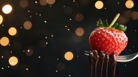 Fresh ripe strawberry on silver fork with dripping chocolate against dark background with golden bokeh lights and sparkles, food photography.