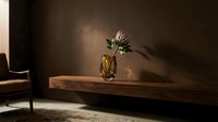 Minimalist interior with single flower in glass vase on wooden shelf, warm sunlight casting shadows on brown wall, contemporary home decor and floral arrangement.