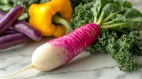 Fresh watermelon radish with vibrant pink and white coloring alongside yellow bell pepper, purple beans and curly kale on marble surface, macro food photography.