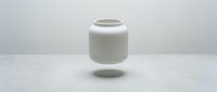 Minimalist white ceramic vase floating above surface with soft shadow on clean background for modern interior design and home decor concepts.