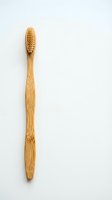 Natural bamboo toothbrush with soft bristles isolated on white background for eco-friendly dental care and sustainable oral hygiene products.