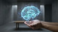 Glowing digital brain hologram floating above open palm in modern office environment representing artificial intelligence and neural networks.