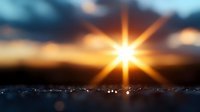 Dramatic sunset with bright starburst sun effect over dark silhouetted horizon, glowing orange and blue sky with lens flare and bokeh lights creating atmospheric mood.