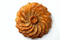 Golden spiral pastry with layered flaky dough arranged in decorative swirled pattern on white background, isolated for bakery and food design projects.