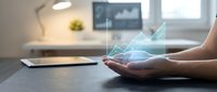 Hands holding glowing digital network connections in modern office workspace representing technology innovation and connectivity solutions for business.