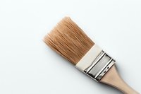 Clean wooden paintbrush with natural bristles and metal ferrule on white background, isolated close-up view for art and craft projects.