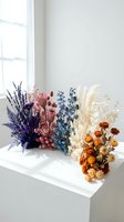 Colorful dried flower bouquets arranged on white windowsill in bright modern interior for home decor and floral design projects.