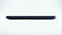 Slim closed laptop seen from the side on white background, showcasing ultra-thin modern design for technology and business concepts.