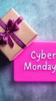 Gift box with sparkly purple bow and pink Cyber Monday sign on textured blue background. Online shopping and holiday season sale concept.