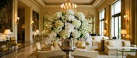 Elegant hotel lobby interior with luxurious white floral arrangement, crystal chandelier, marble floors and classic furniture for hospitality design.