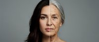 Split face portrait showing aging process from young to elderly woman with wrinkles and gray hair transformation on neutral background for skincare concepts.