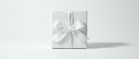 White gift box with elegant satin ribbon bow on clean background for holiday celebrations, birthdays, weddings and special occasions packaging design.