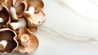 Sliced mushrooms with gills exposed on white marble surface, overhead view for culinary and food styling projects.