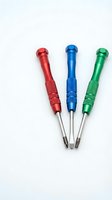 Three colorful precision screwdrivers with textured grips in red, blue and green isolated on white background for repair and maintenance work.