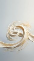 Creamy white liquid swirling in dynamic spiral motion against soft gradient background creating elegant flowing pattern for luxury product advertising.