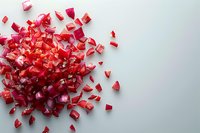 Fresh red onion chopped into small pieces scattered on white background, creating dynamic food composition perfect for cooking blogs and culinary presentations.