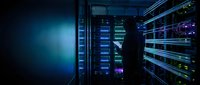 Modern data center server room with glowing blue LED lights and network equipment racks for cloud computing and digital infrastructure technology solutions.