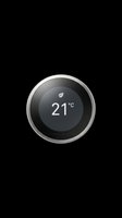 Smart round thermostat with black display showing 21 degrees celsius, isolated on transparent background, ready for tech, home, and print on demand design use.