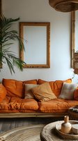 Cozy bohemian living room with orange sofa, wicker pendant light, palm plant and wooden mirror frame creating warm earthy interior design atmosphere.