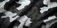 Black and white military camouflage pattern on fabric with textured surface, creating contrast between dark and light areas for tactical concealment.