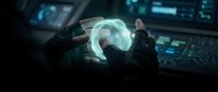 Futuristic astronaut operating holographic interface in spaceship cockpit with glowing blue displays and advanced control panels for sci-fi projects.