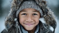 Happy mixed-race child wearing fur-trimmed winter hat smiling in snowy weather. Warm winter clothing portrait for seasonal advertising and family content.