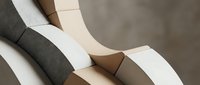 Rolled fabric swatches in neutral tones of charcoal, cream, and taupe display textile samples for interior design, fashion, and upholstery selection projects.