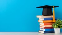 Academic graduation cap with gold tassel on stack of colorful books against vibrant blue wall background with decorative plant, symbolizing education achievement.
