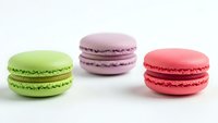 Three colorful French macarons in green, purple and pink on white background. Sweet dessert cookies isolated for bakery menu design.