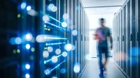 IT technician walking through a modern data center corridor with glowing network nodes and server racks in blue light.