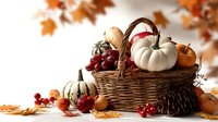 Autumn harvest basket with white and orange pumpkins, gourds, grapes, and pine cones surrounded by fallen maple leaves on white background. Perfect for seasonal marketing.