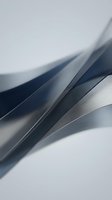 Abstract flowing metallic waves with smooth curves and gradients in silver and gray tones for modern digital design backgrounds.