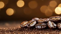 Fresh roasted coffee beans with golden bokeh lights in background, macro shot showing rich texture and aroma on dark surface with coffee grounds.