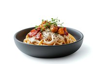 Homemade pasta with rich tomato sauce, topped with fresh herbs and black pepper in a modern gray ceramic bowl on white background.