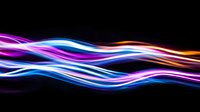 Glowing neon light waves with vibrant purple, blue, and orange colors flowing on black background, abstract dynamic energy lines for modern design projects.