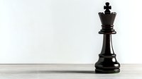 Black chess queen piece standing alone on light wooden surface against white background, symbolizing leadership and strategy in business and game concepts.