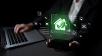 Businessman presenting green eco house icon with digital interface elements and financial symbols for sustainable real estate technology solutions.