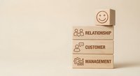 Wooden blocks with business icons stacked showing relationship, customer and management concepts for corporate strategy and organizational development.