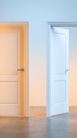 Two white interior doors in modern home hallway with warm and cool lighting effects creating gradient atmosphere for residential design projects.