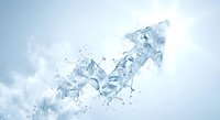 Clear water splash forming dynamic arrow shape pointing upward against white background with droplets and motion blur for business growth concepts.