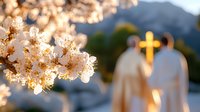 Spring cherry blossoms frame romantic scene of couple in white standing before illuminated cross at mountain church during sunset wedding ceremony.