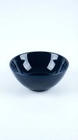 Dark navy blue glossy ceramic bowl isolated on white background, showcasing sleek modern kitchenware design for food styling and product photography.
