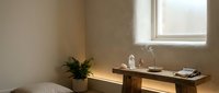 Modern minimalist bathroom interior with wooden vanity, white bathtub, and natural lighting creating serene spa-like atmosphere for home design inspiration.