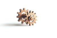 Wooden gear wheels on white background with selective focus and shallow depth of field, symbolizing mechanics, engineering and teamwork concepts.