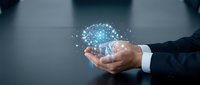 Businessman hands holding glowing digital brain with network connections representing artificial intelligence and machine learning technology concepts.