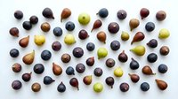Fresh grapes in various colors including red, green, and black varieties arranged on white background, suitable for food photography, culinary design, and healthy eating content.