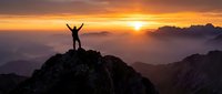 Person celebrating success on mountain peak at golden sunrise with arms raised in triumph over layered mountain ranges.