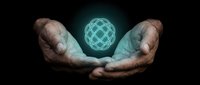 Cupped hands protecting glowing geometric sphere with intricate wireframe pattern on dark background symbolizing innovation and digital transformation.