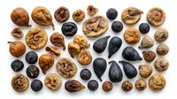 Assorted nuts and seeds including walnuts, black seeds, and dried fruits arranged on white background, suitable for food photography, nutrition content, healthy eating concepts, and culinary design projects.